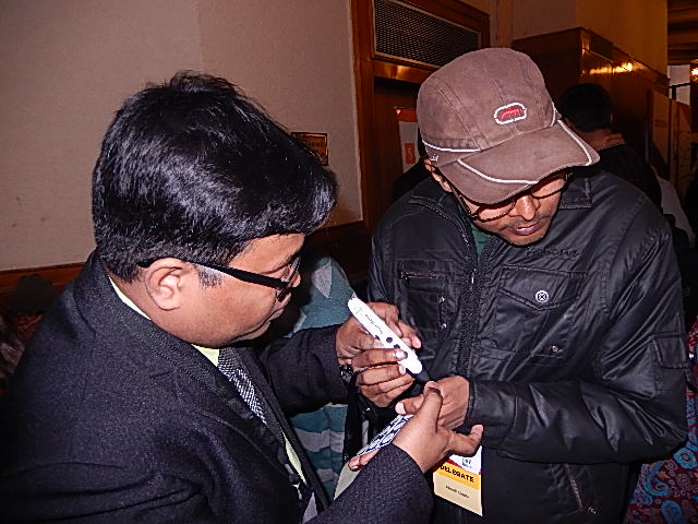 A BarrierBreak employee demonstrates Touch Memo, a voice-activated label maker, to a visually impaired individual