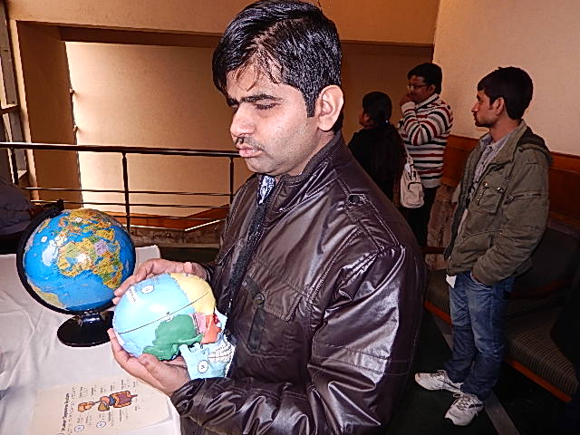 A man reads a skull model with Braille at Techshare 2014.